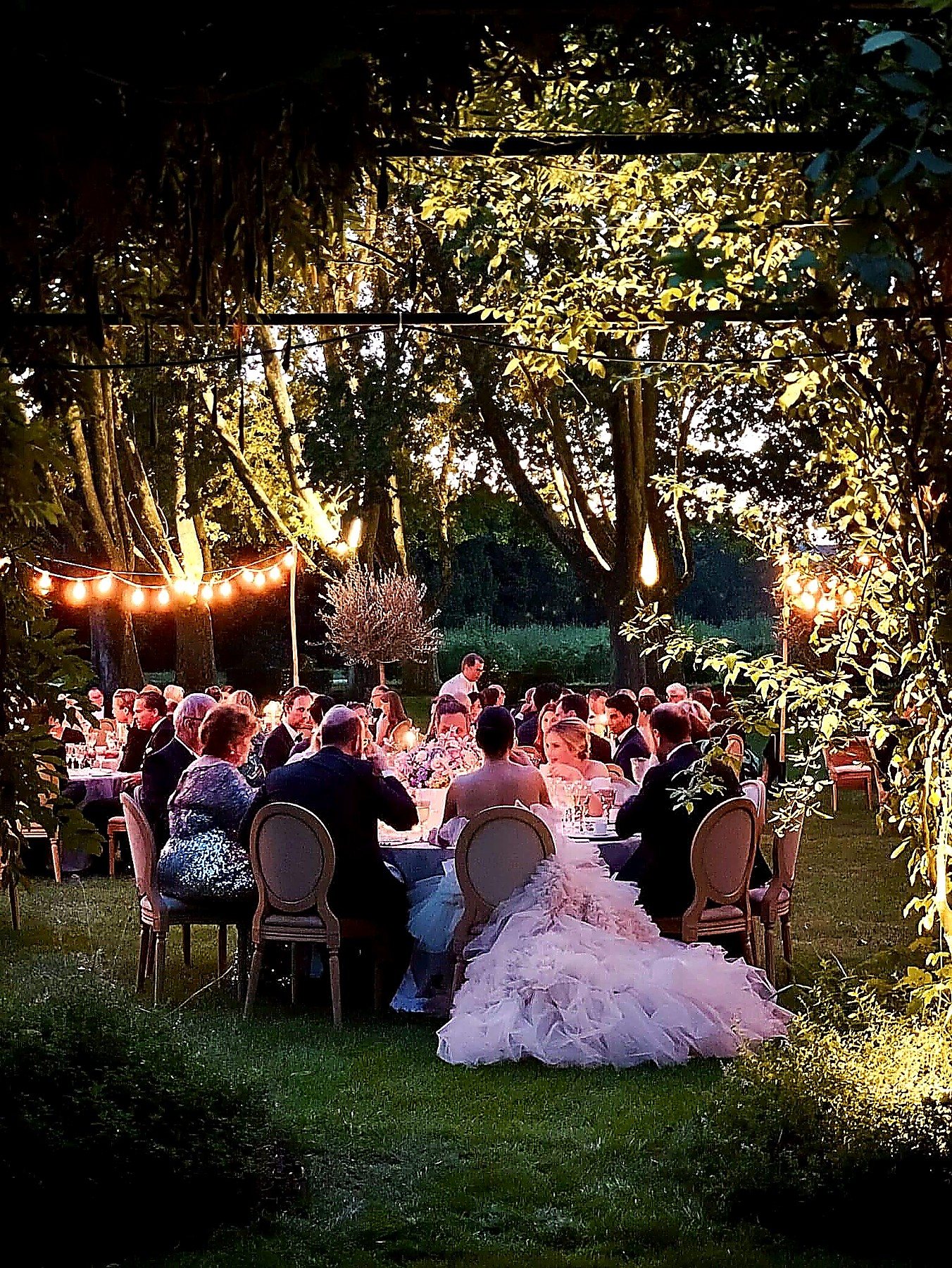 Romantic outdoor wedding dinner under string lights — destination wedding videography by HD Moments