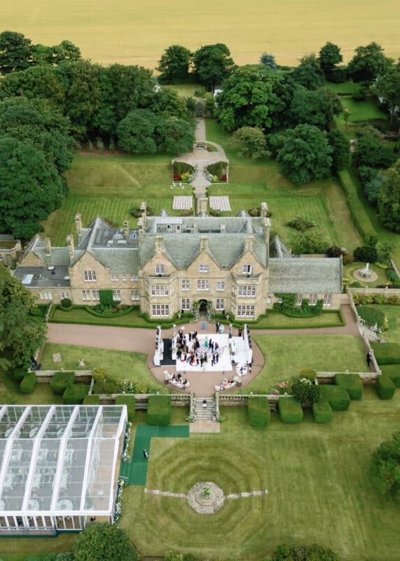 Aerial view of a wedding by the sea in North Berwick, captured by wedding videographer London.