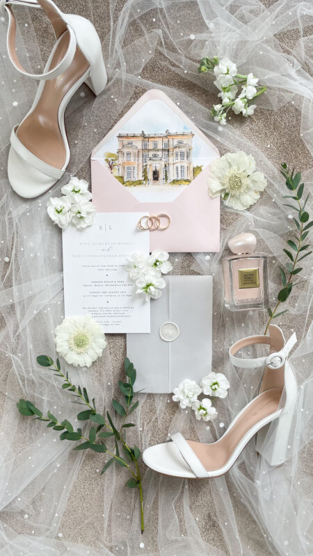 Elegant bridal details with white flowers, luxury wedding shoes, and perfume flat lay