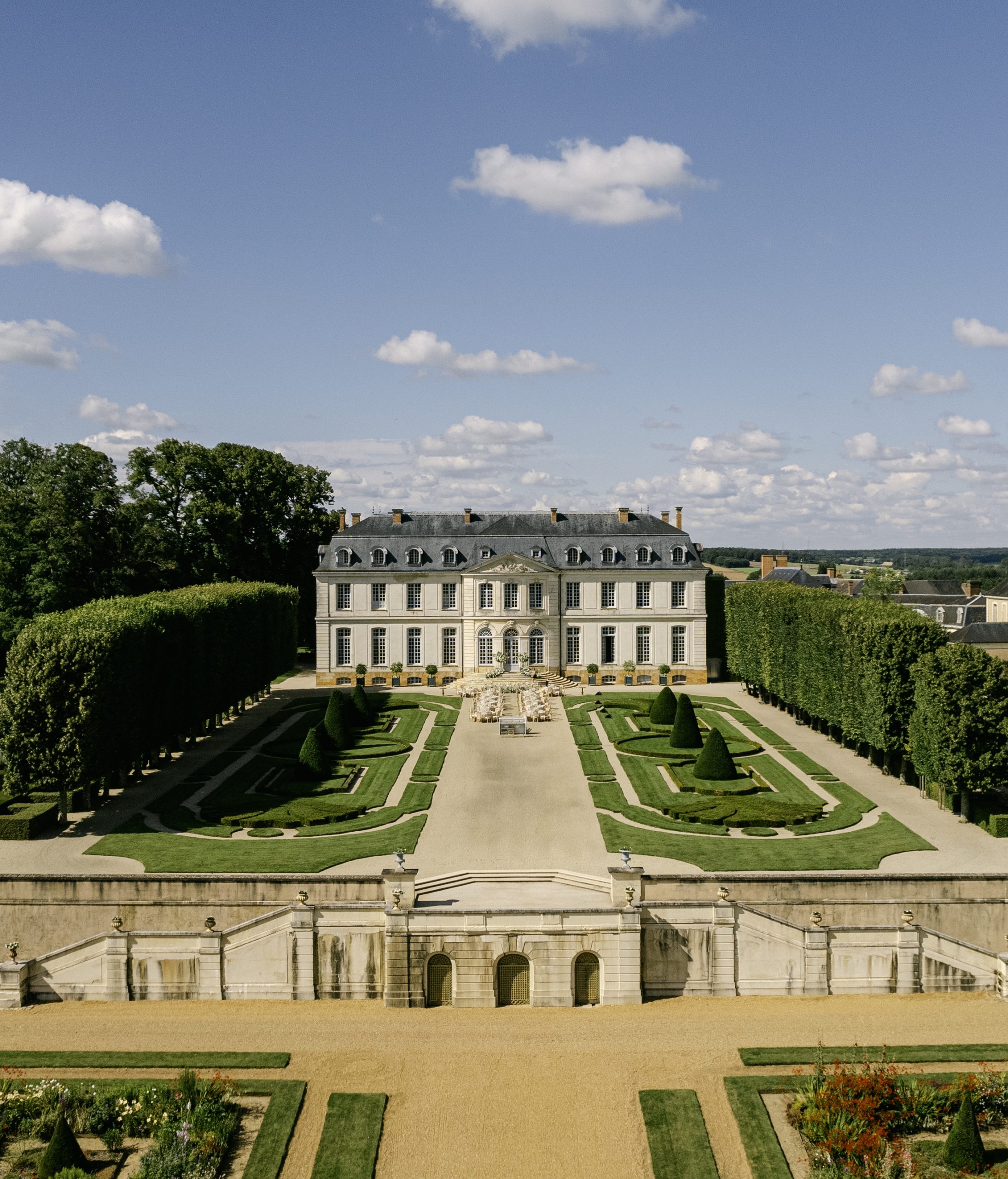 Aerial drone view of Château du Grand-Lucé with formal French gardens and neoclassical façade — Genevieve and Jack's three-day wedding in the Loire Valley, France — HD Moments