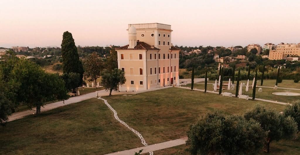Outdoor wedding reception at Tenuta Villa York, Rome — aerial view of dinner tables and dance floor at golden hour